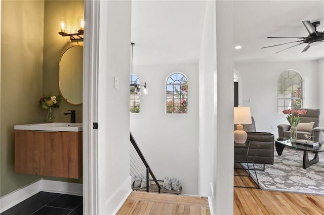 2526 Metairie Rd, Metairie, LA 70001 - hallway with a sink, wood finished floors, and arched walkways