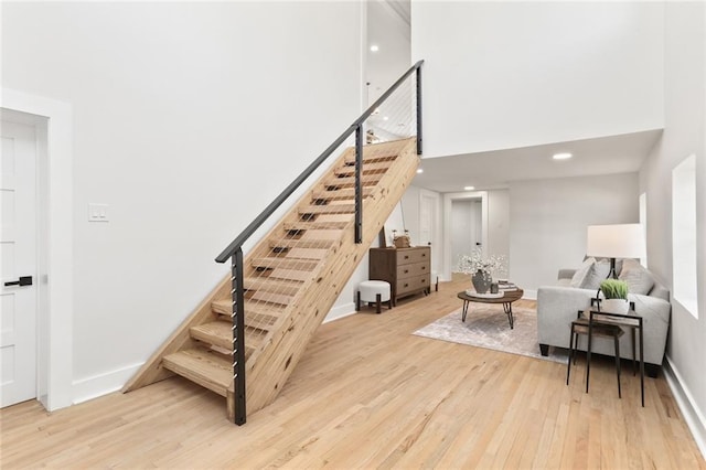 2526 Metairie Rd, Metairie, LA 70001 - stairway with wood finished floors, a towering ceiling, baseboards, and recessed lighting