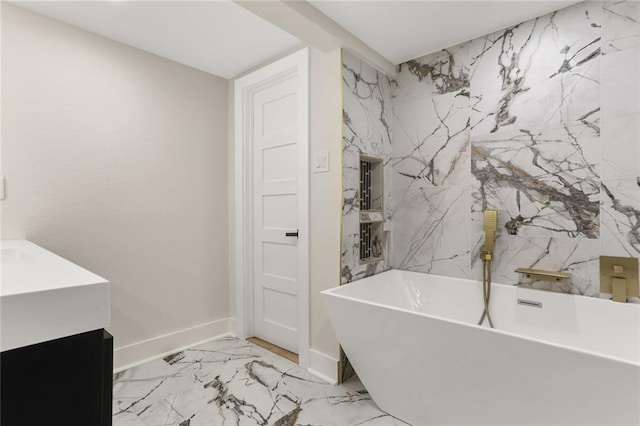 2526 Metairie Rd, Metairie, LA 70001 - bathroom featuring a freestanding tub, vanity, marble finish flooring, and baseboards
