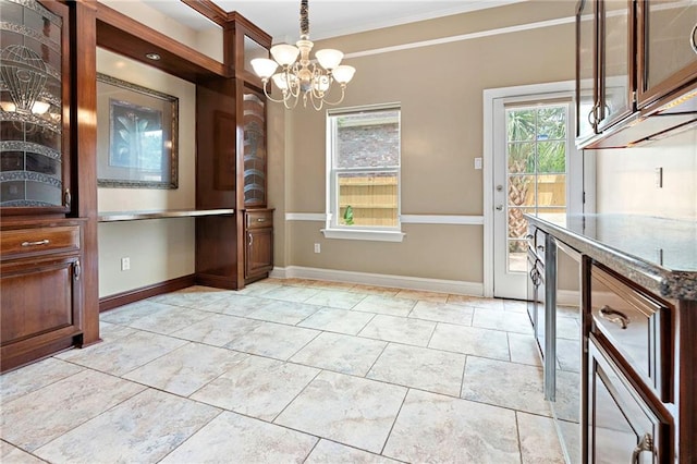 1 Miller Ln, Metairie, LA 70002 - unfurnished dining area featuring a chandelier, crown molding, and baseboards