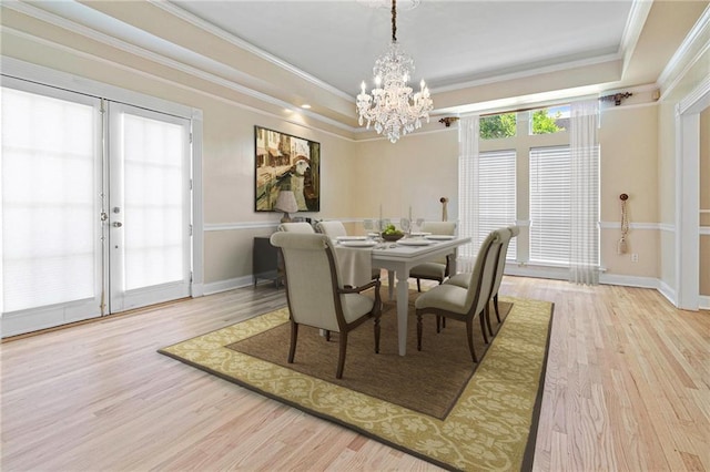 1 Miller Ln, Metairie, LA 70002 - dining area featuring a chandelier, wood finished floors, a tray ceiling, and crown molding