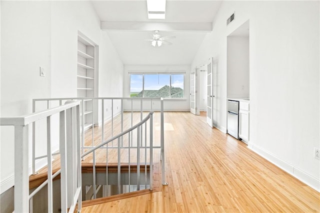 1 Miller Ln, Metairie, LA 70002 - hallway featuring light wood-type flooring, an upstairs landing, vaulted ceiling, and baseboards