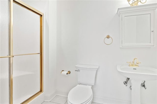 1 Miller Ln, Metairie, LA 70002 - bathroom with toilet, a shower with door, baseboards, and tile patterned flooring