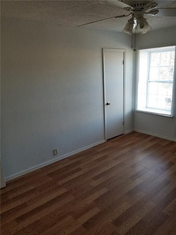 6220 Riverside Dr Unit 556, Metairie, LA 70003 - empty room with ceiling fan, dark wood-style floors, and baseboards