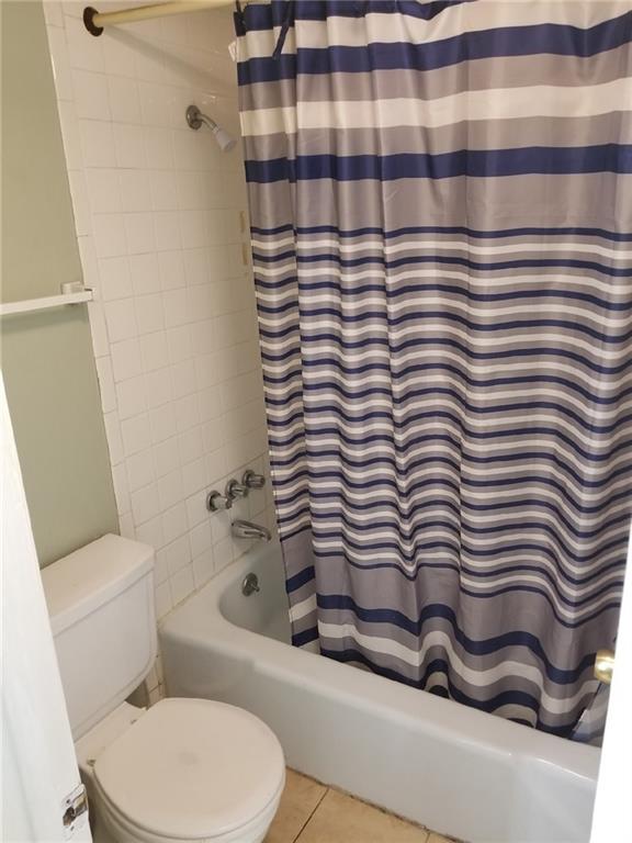 6220 Riverside Dr Unit 556, Metairie, LA 70003 - bathroom with toilet, shower / bath combination with curtain, and tile patterned floors