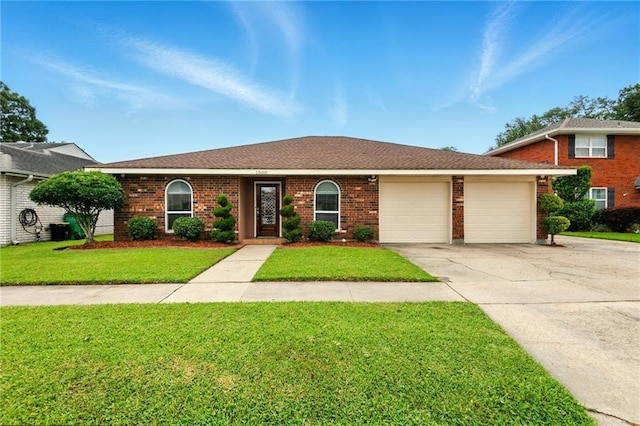 1900 Woods Dr, Metairie, LA 70001 - view of front of home featuring concrete driveway, a garage, a front lawn, and brick siding