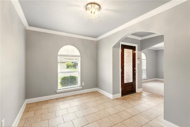 1900 Woods Dr, Metairie, LA 70001 - unfurnished room with arched walkways, ornamental molding, baseboards, light tile patterned floors, and a chandelier