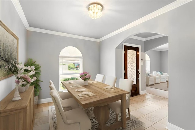 1900 Woods Dr, Metairie, LA 70001 - dining area with plenty of natural light, arched walkways, ornamental molding, and baseboards