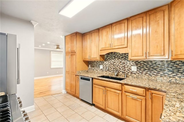 1900 Woods Dr, Metairie, LA 70001 - kitchen with dishwasher, a sink, decorative backsplash, and light stone countertops