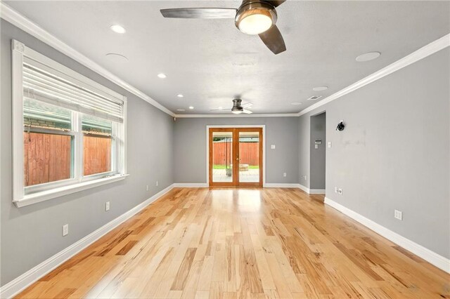 1900 Woods Dr, Metairie, LA 70001 - spare room with a ceiling fan, healthy amount of natural light, light wood-style floors, ornamental molding, and baseboards