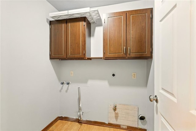 1900 Woods Dr, Metairie, LA 70001 - washroom with hookup for an electric dryer, cabinet space, light wood finished floors, washer hookup, and baseboards