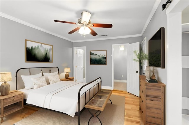 1900 Woods Dr, Metairie, LA 70001 - bedroom featuring light wood finished floors, crown molding, baseboards, and a ceiling fan