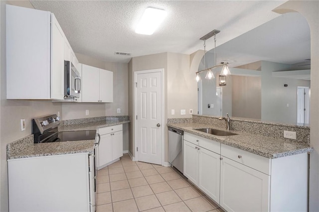 1556 Cherry St, Slidell, LA 70460 - kitchen featuring stainless steel appliances, a sink, white cabinets, a textured ceiling, and light tile patterned floors