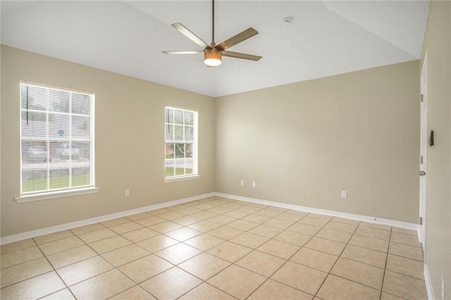 1556 Cherry St, Slidell, LA 70460 - empty room with a ceiling fan, vaulted ceiling, light tile patterned flooring, and baseboards