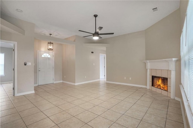 1556 Cherry St, Slidell, LA 70460 - unfurnished living room featuring light tile patterned floors, a ceiling fan, a fireplace, and baseboards