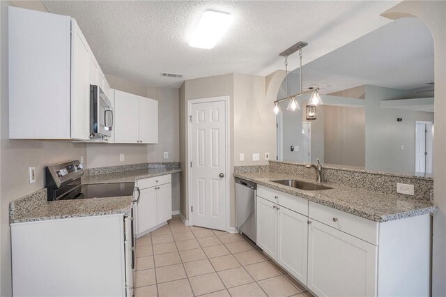 1556 Cherry St, Slidell, LA 70460 - kitchen featuring stainless steel appliances, a sink, white cabinets, a textured ceiling, and light tile patterned floors