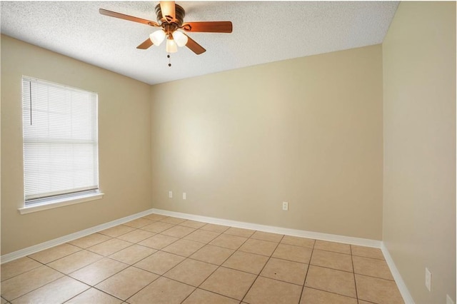 1556 Cherry St, Slidell, LA 70460 - spare room featuring ceiling fan, a textured ceiling, light tile patterned floors, and baseboards