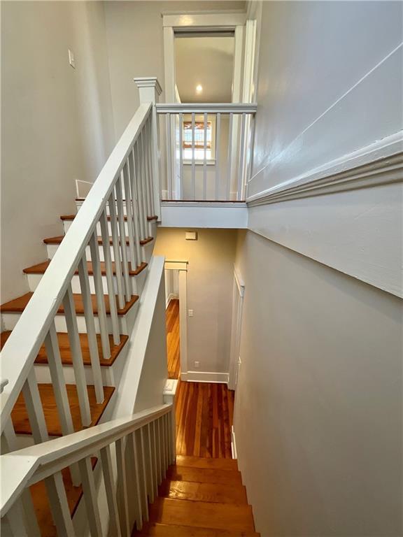 402527 Constance St, New Orleans, LA 70115 - staircase with wood finished floors and baseboards