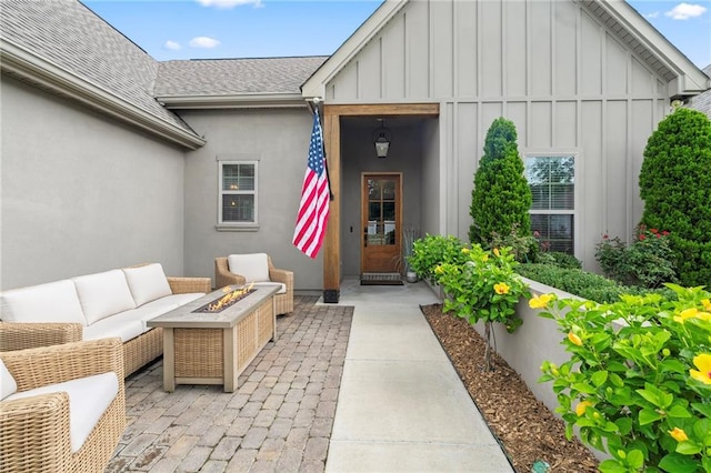 421 Tiger Ave, Covington, LA 70433 - doorway to property with board and batten siding, a shingled roof, an outdoor living space, and a patio