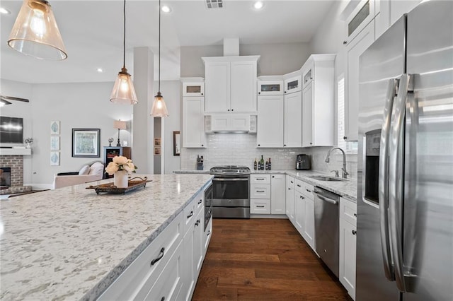421 Tiger Ave, Covington, LA 70433 - kitchen with stainless steel appliances, a sink, open floor plan, recessed lighting, and light stone counters