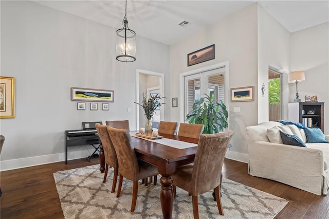 421 Tiger Ave, Covington, LA 70433 - dining space with a towering ceiling, wood finished floors, and baseboards