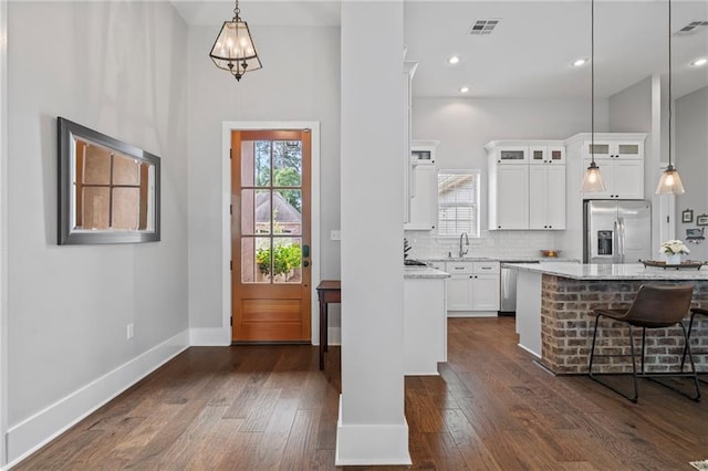 421 Tiger Ave, Covington, LA 70433 - kitchen featuring appliances with stainless steel finishes, glass insert cabinets, dark wood-style flooring, plenty of natural light, and recessed lighting