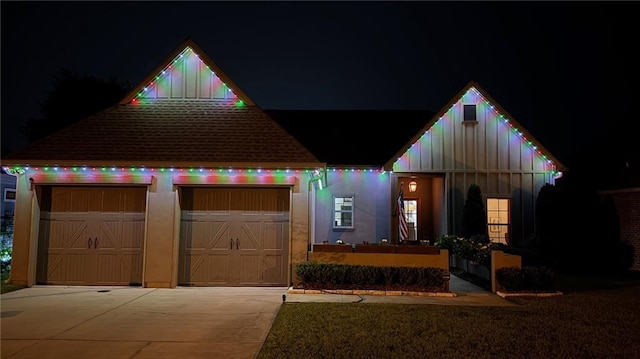 421 Tiger Ave, Covington, LA 70433 - view of front facade featuring board and batten siding, concrete driveway, and a garage