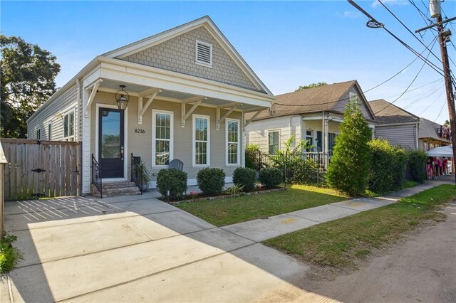 8236 S Claiborne Ave, New Orleans, LA 70118 - shotgun-style home with a gate