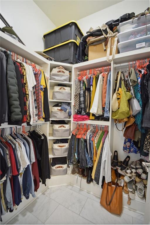 8236 S Claiborne Ave, New Orleans, LA 70118 - walk in closet featuring marble look tile flooring