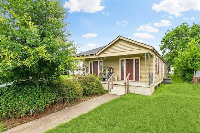 220002 Delille St, Chalmette, LA 70043 - view of front facade with covered porch and a front lawn