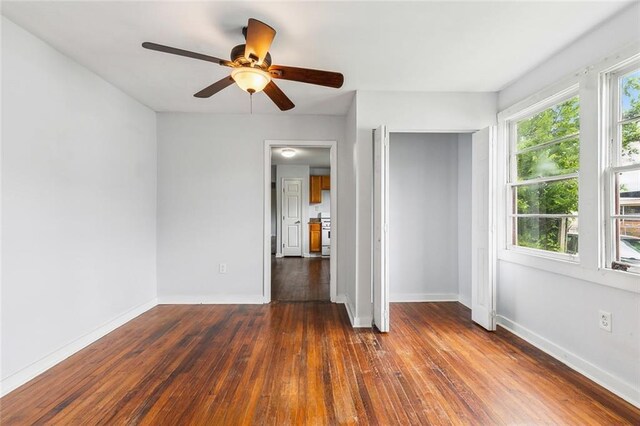 220002 Delille St, Chalmette, LA 70043 - unfurnished bedroom with dark wood-style floors, baseboards, a closet, and ceiling fan