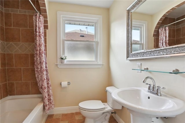 6550 General Diaz St, New Orleans, LA 70124 - bathroom featuring baseboards, toilet, shower / bathtub combination with curtain, and a sink