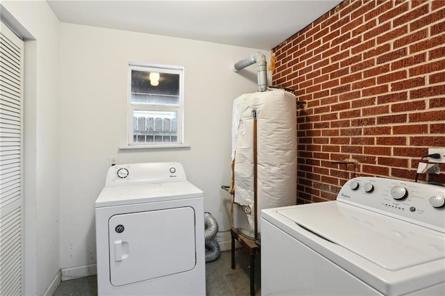 6550 General Diaz St, New Orleans, LA 70124 - washroom with washing machine and dryer, brick wall, and baseboards