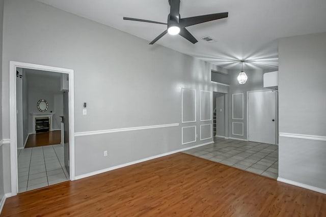 1550 De Battista Pl, New Orleans, LA 70131 - spare room with ceiling fan, wood finished floors, a fireplace, and baseboards