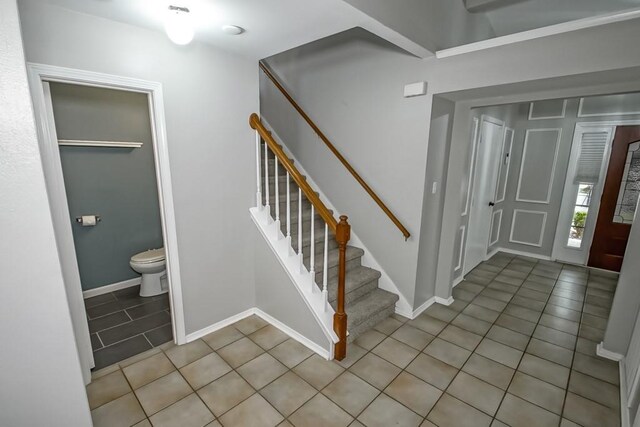 1550 De Battista Pl, New Orleans, LA 70131 - entrance foyer with light tile patterned floors, stairs, and baseboards