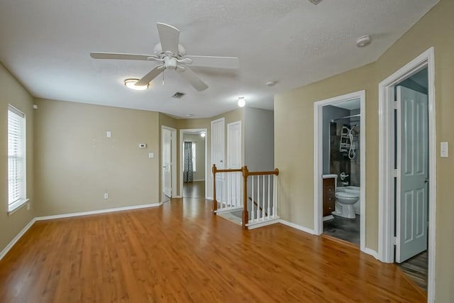 1550 De Battista Pl, New Orleans, LA 70131 - spare room with ceiling fan, light wood-style floors, baseboards, a textured ceiling, and a smoke detector