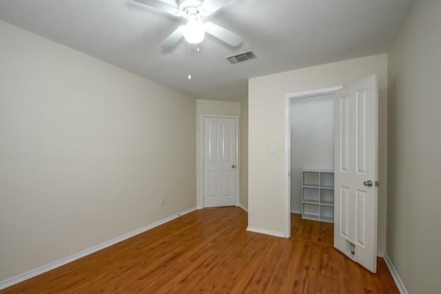 1550 De Battista Pl, New Orleans, LA 70131 - unfurnished bedroom with light wood-type flooring, baseboards, ceiling fan, and a closet