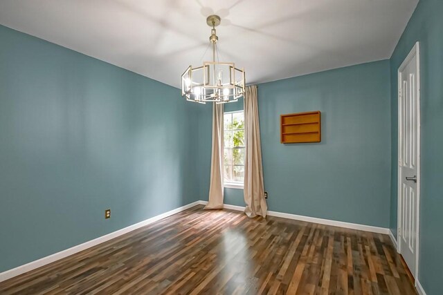 1550 De Battista Pl, New Orleans, LA 70131 - unfurnished room with a chandelier, baseboards, and dark wood finished floors