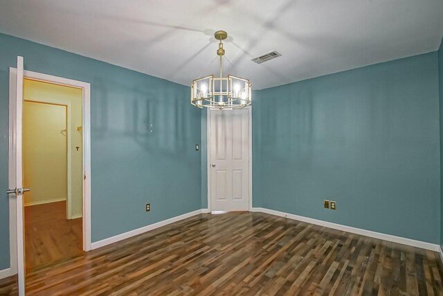1550 De Battista Pl, New Orleans, LA 70131 - spare room with a chandelier, dark wood finished floors, and baseboards