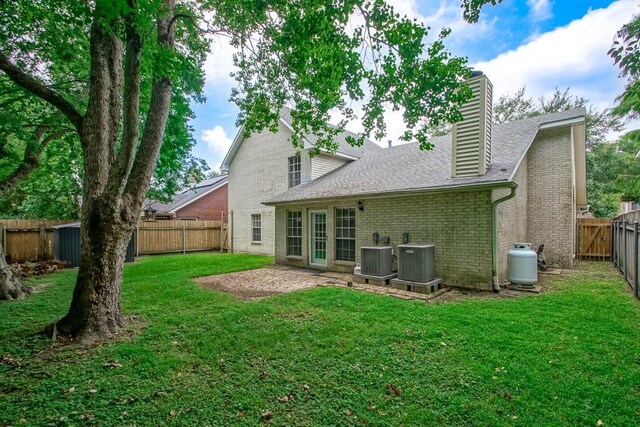1550 De Battista Pl, New Orleans, LA 70131 - back of property with brick siding, a chimney, cooling unit, and a shingled roof
