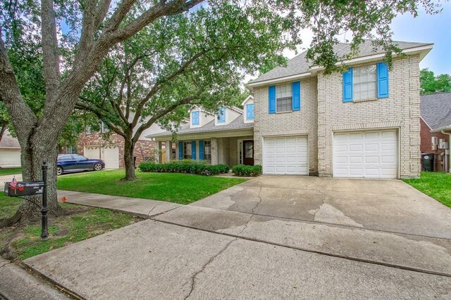 1550 De Battista Pl, New Orleans, LA 70131 - traditional-style house featuring brick siding, driveway, a front lawn, and an attached garage