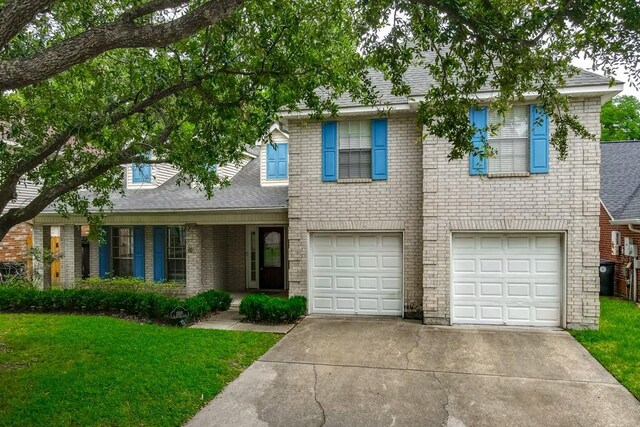 1550 De Battista Pl, New Orleans, LA 70131 - view of front of home featuring concrete driveway, a garage, a front yard, and brick siding