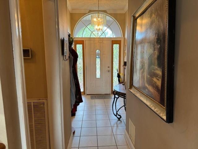 203 Lorelei Cir, Slidell, LA 70458 - entryway featuring ornamental molding, a chandelier, and light tile patterned flooring