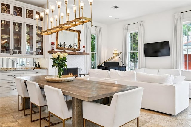 2538 N Rampart St, New Orleans, LA 70117 - dining space featuring plenty of natural light, a warm lit fireplace, and recessed lighting