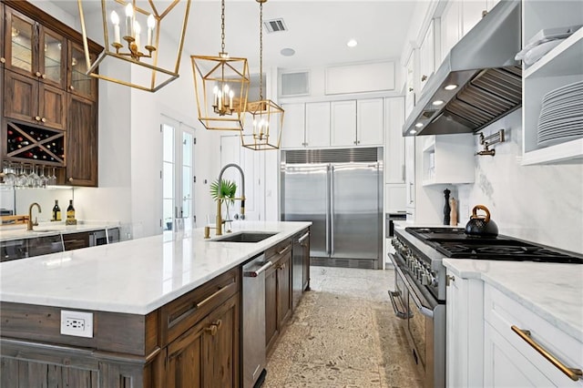 2538 N Rampart St, New Orleans, LA 70117 - kitchen with premium appliances, range hood, a chandelier, white cabinets, and glass insert cabinets