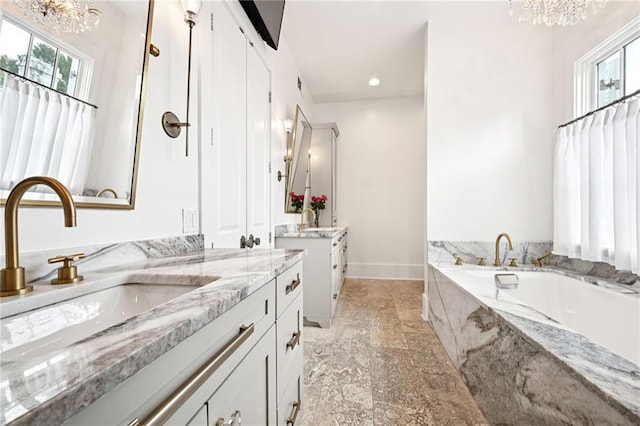 2538 N Rampart St, New Orleans, LA 70117 - bathroom with a chandelier, two vanities, healthy amount of natural light, and recessed lighting