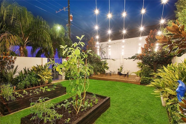 2538 N Rampart St, New Orleans, LA 70117 - yard at twilight with a vegetable garden and a wooden deck