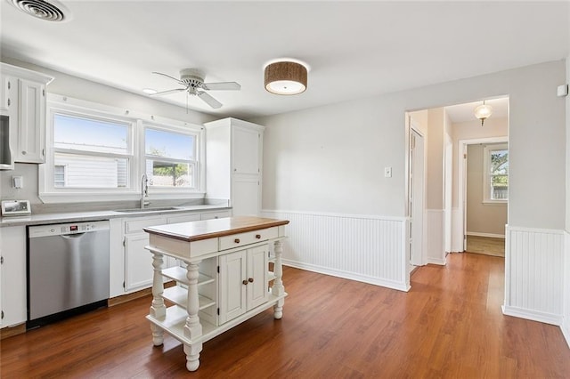 725 N Turnbull Dr, Metairie, LA 70001 - kitchen with dishwasher, a sink, white cabinetry, a ceiling fan, and wainscoting