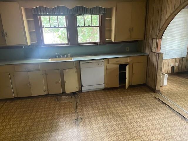 312 Central Ave, Reserve, LA 70084 - kitchen with white dishwasher, open shelves, light countertops, wooden walls, and a sink