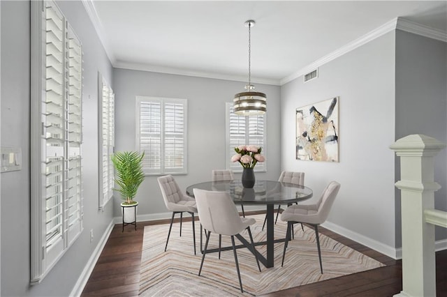 5830 Marshal Foch St, New Orleans, LA 70124 - dining space featuring wood finished floors, a chandelier, and crown molding